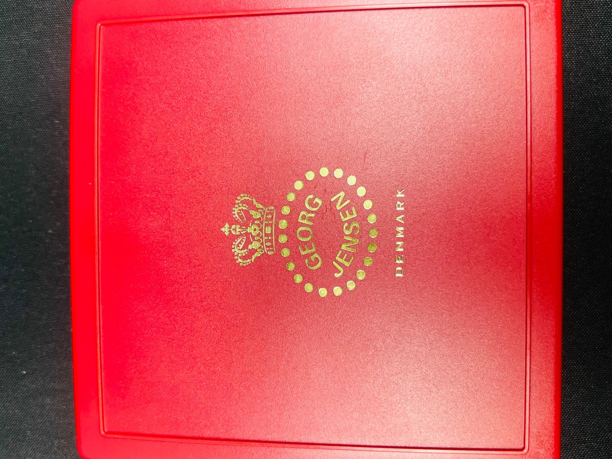 Red box with Georg Jensen logo on a black background