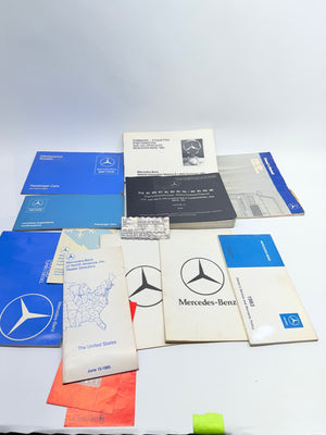 Collection of Mercedes-Benz manuals and documents on a white background