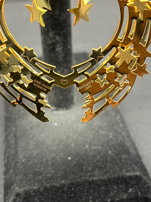 Gold decorative item with stars on a gray background