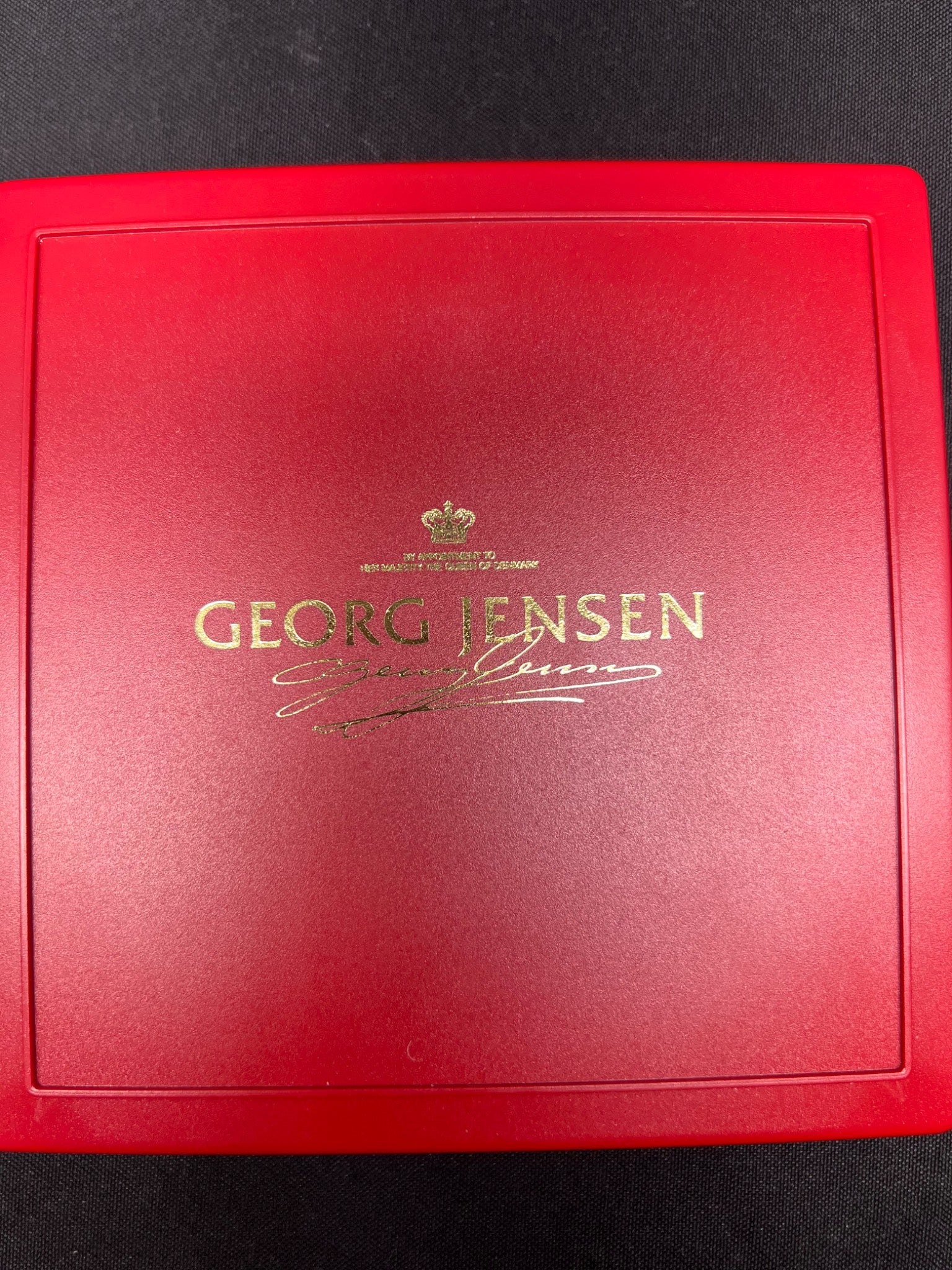 Red box with Georg Jensen logo on a black background