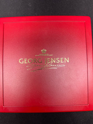 Red box with Georg Jensen logo on a black background