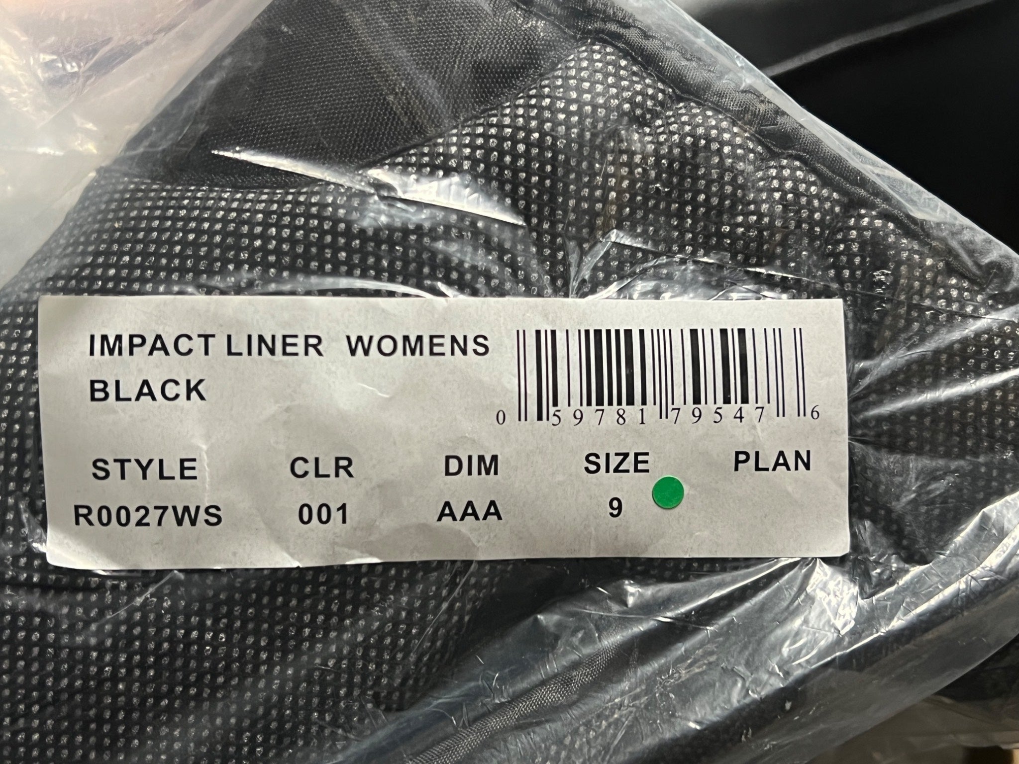 Black impact liner women's product in packaging with a label.