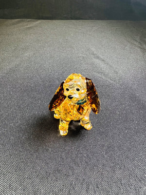 Crystal dog figurine on a gray surface