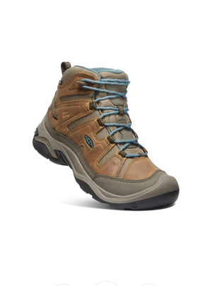 Brown hiking boot with blue laces on a white background