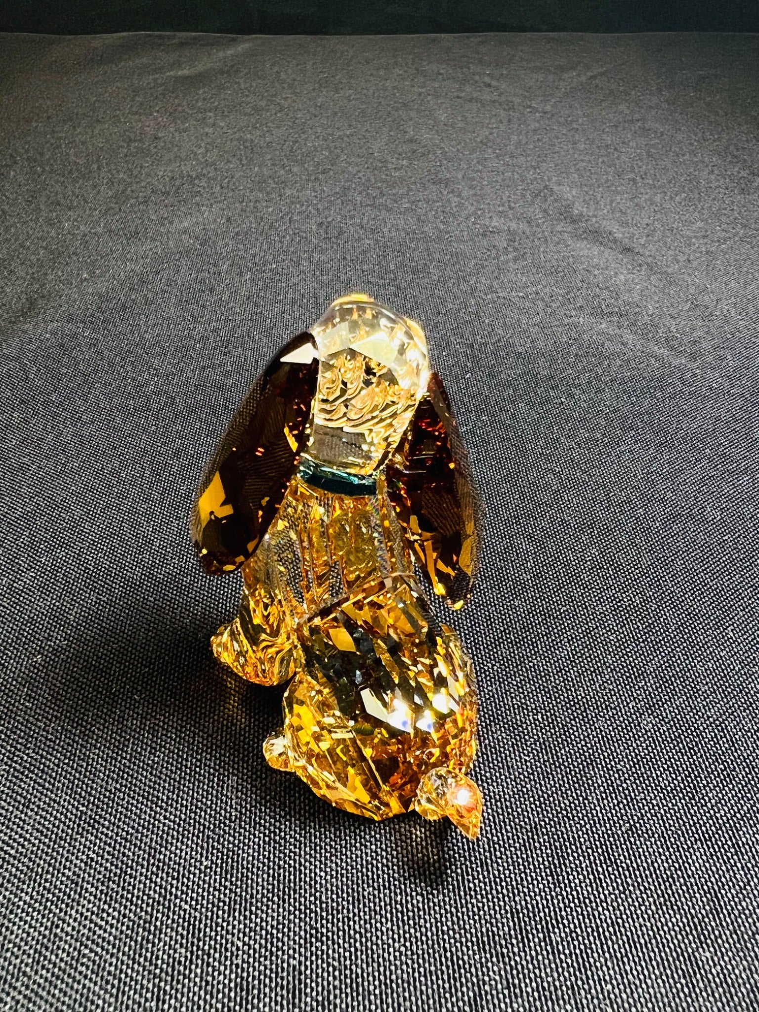 Crystal dog figurine on a dark gray background