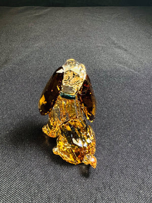 Crystal dog figurine on a dark gray background