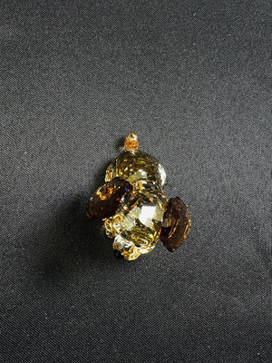 Decorative brooch with gemstones on a dark fabric background
