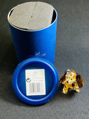 Blue Swarovski box with a crystal animal figure on a gray surface
