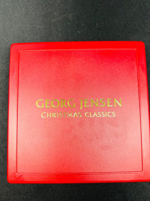 Red box with 'Georg Jensen Christmas Classics' text on a dark background
