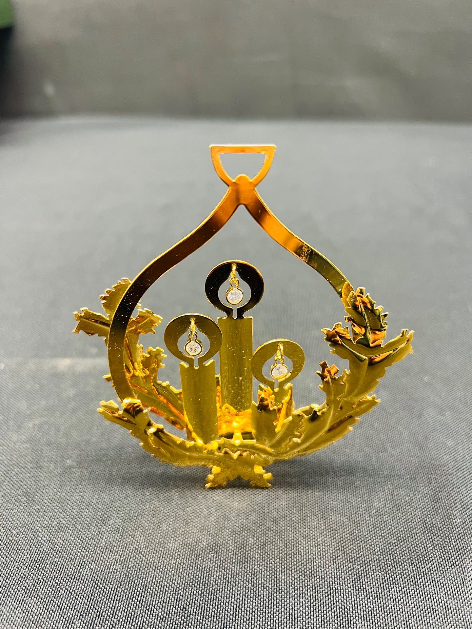 Gold decorative item on a gray surface