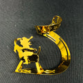 Gold decorative item shaped like a number '5' with a silhouette of a person on a horse against a black background