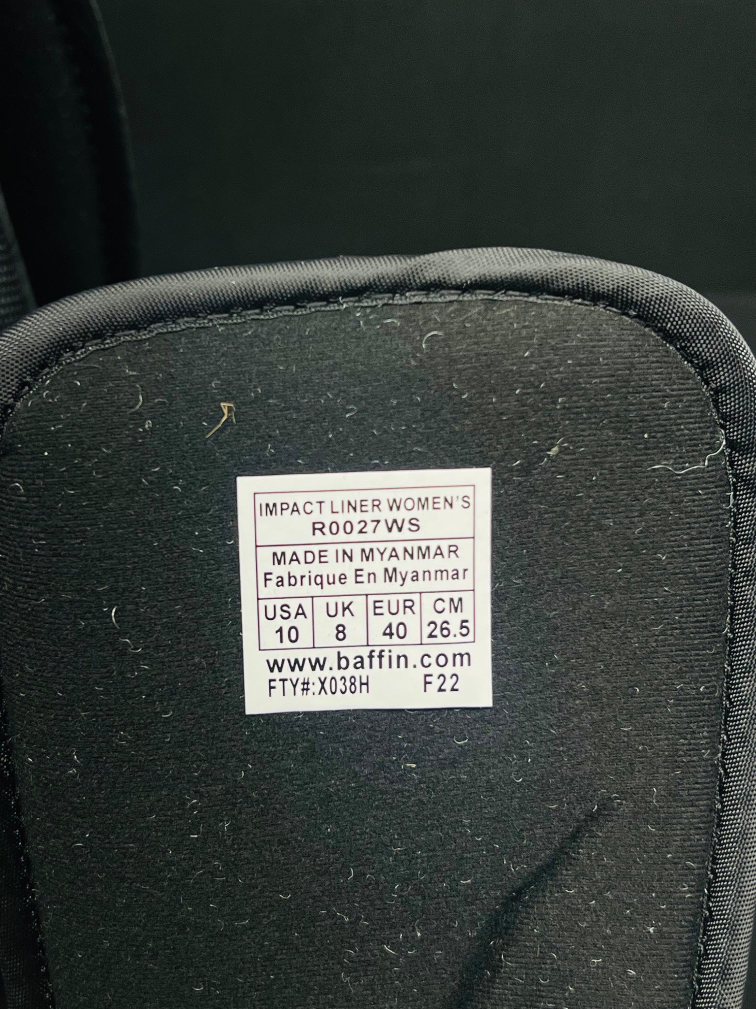 Black product with a label on a dark background