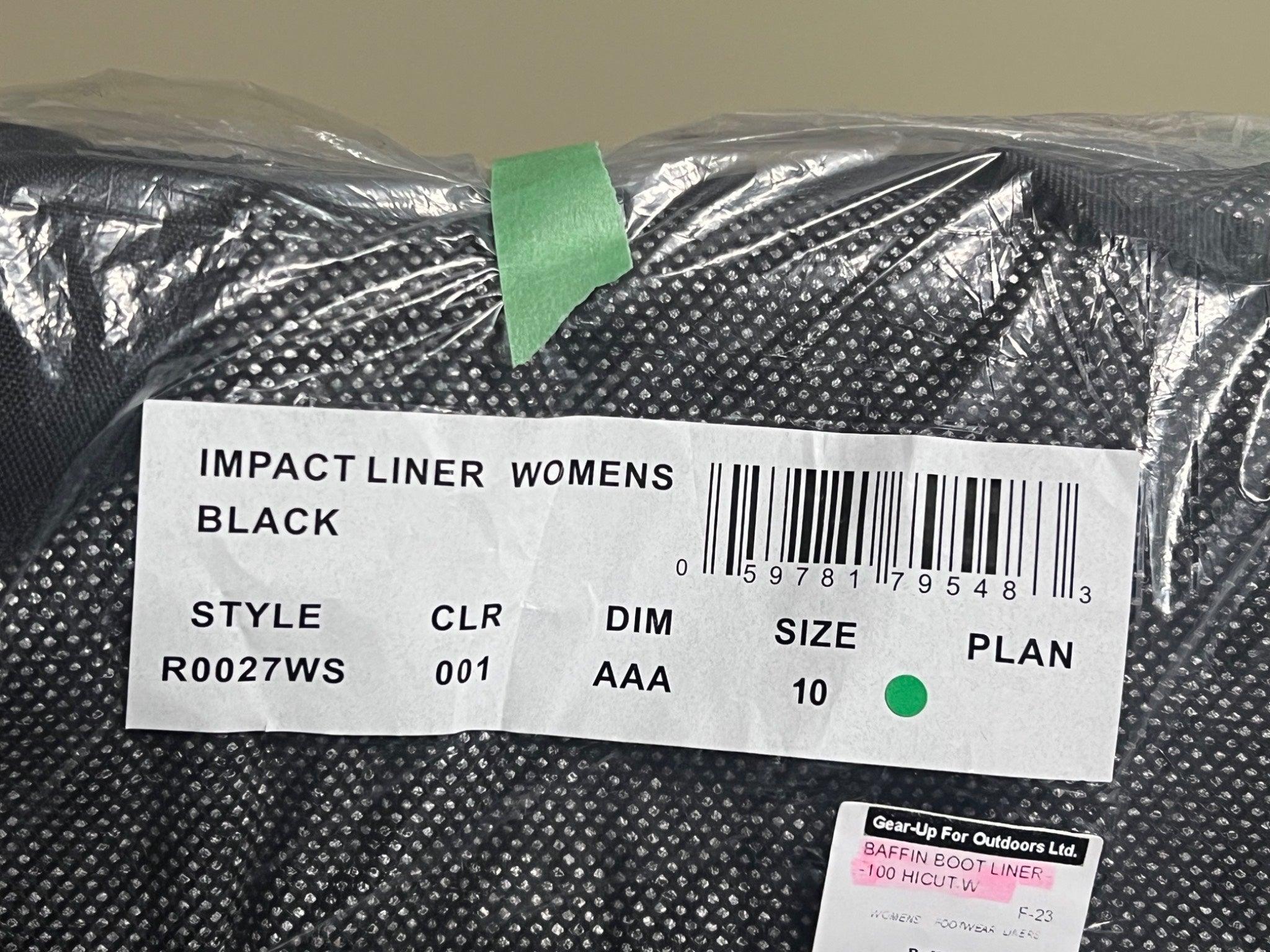 Black impact liner with a label on a gray background