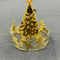 Gold Christmas tree-shaped cutout on a gray background