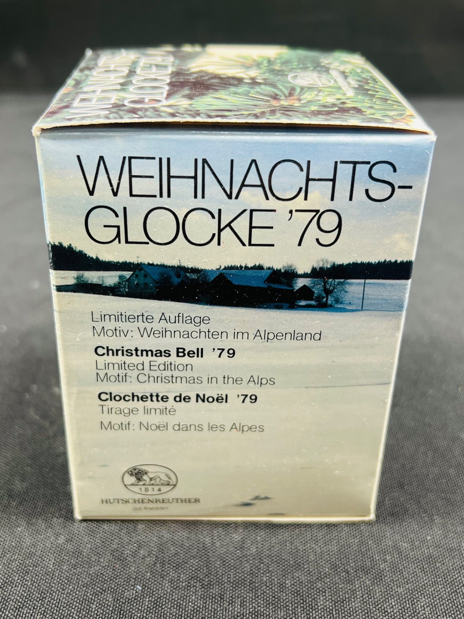 Box labeled 'Weihnachts-Glocke '79' with Christmas scene design on a gray background