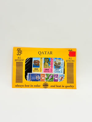 Box of stamps with various designs and 'Qatar' branding on a light gray background