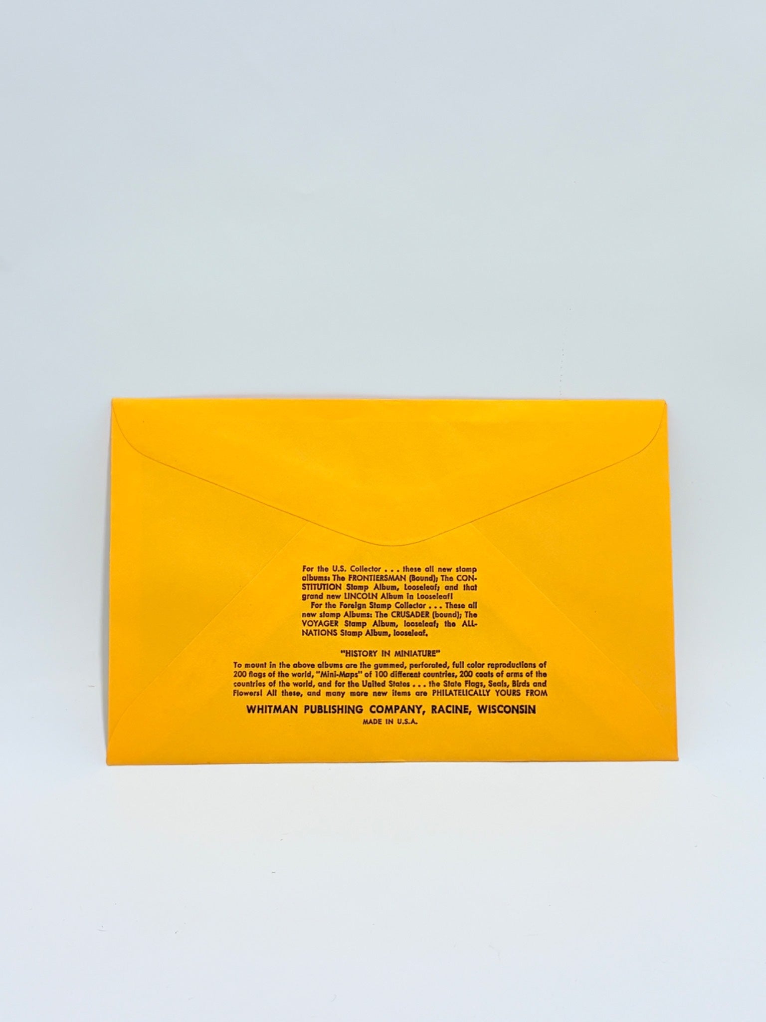 Yellow envelope with black text on a light gray background