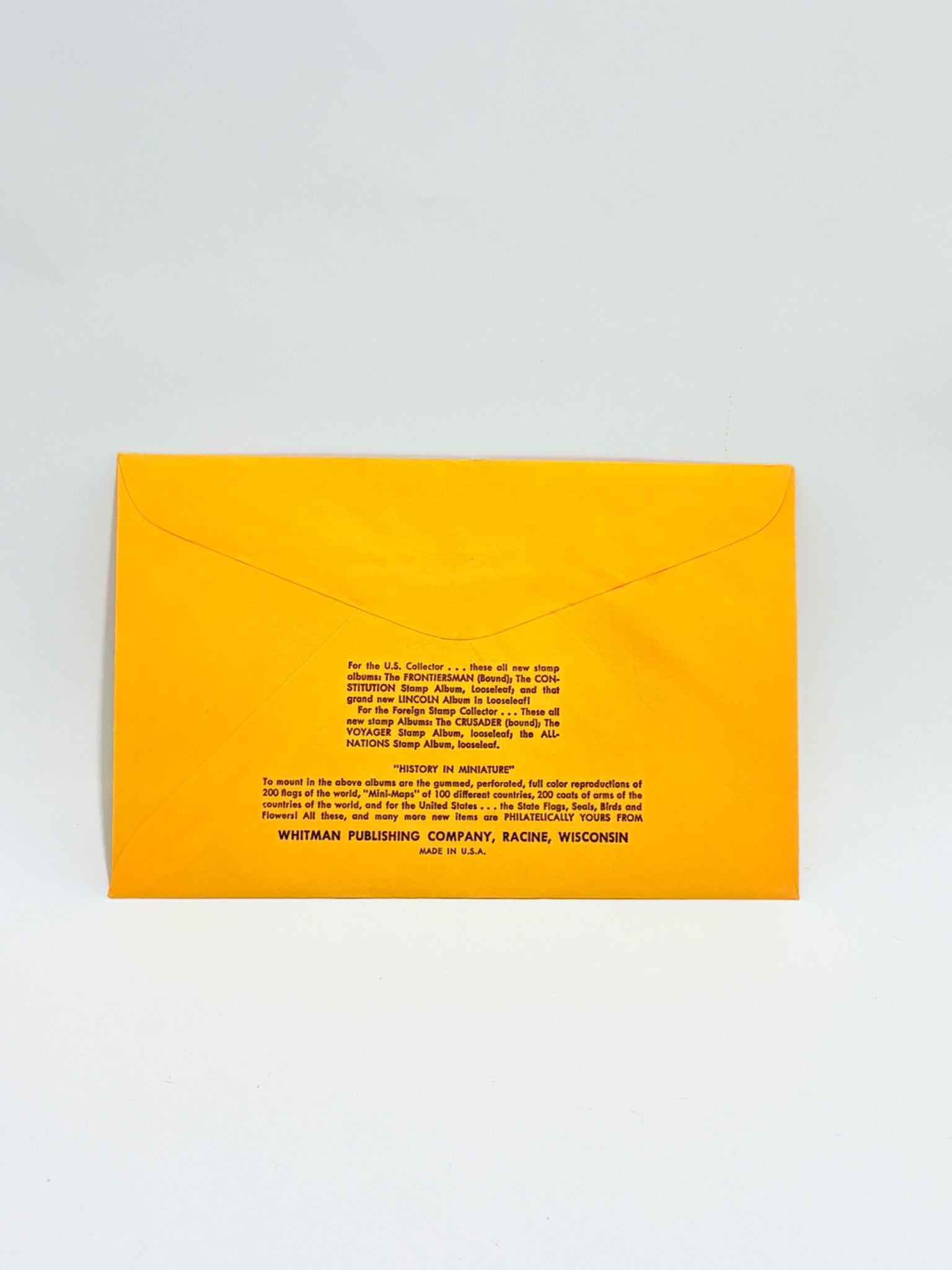 Yellow envelope with black text on a light gray background