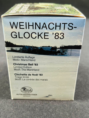 Box with 'Weihnachts-Glocke '83' text and winter scene on a gray background
