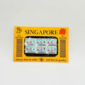Vintage Singapore postage stamp book with yellow cover and black text on a white background