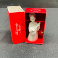 Decorative angel figurine in a red box on a gray surface