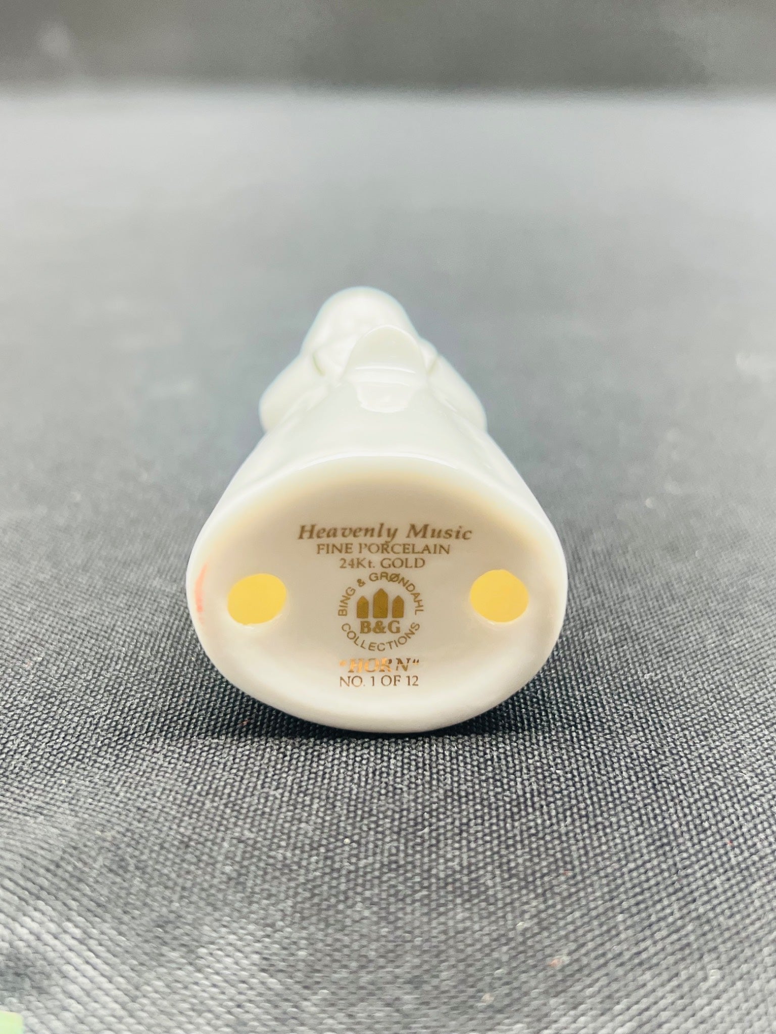 Small white decorative item with 'Heavenly Music' text on a gray background