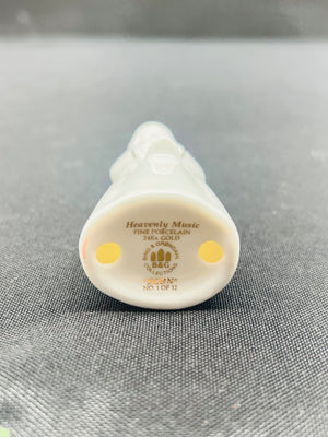 Small white decorative item with 'Heavenly Music' text on a gray background