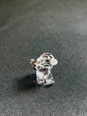 Crystal dog figurine on a textured gray surface