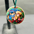 Colorful pendant with cartoon characters on a stand against a neutral background