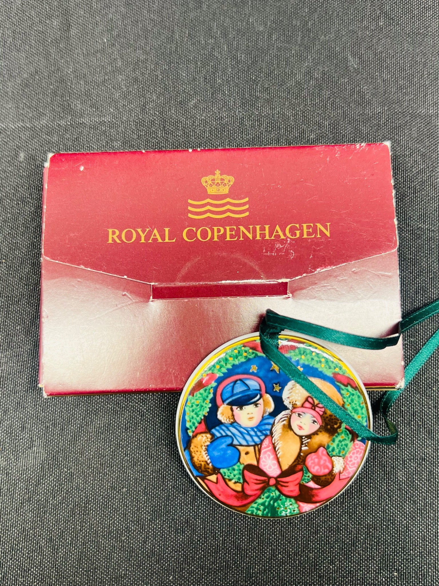 Decorative ornament with 'Royal Copenhagen' packaging on a gray surface