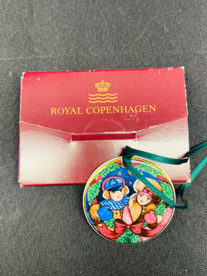 Decorative ornament with 'Royal Copenhagen' packaging on a gray surface