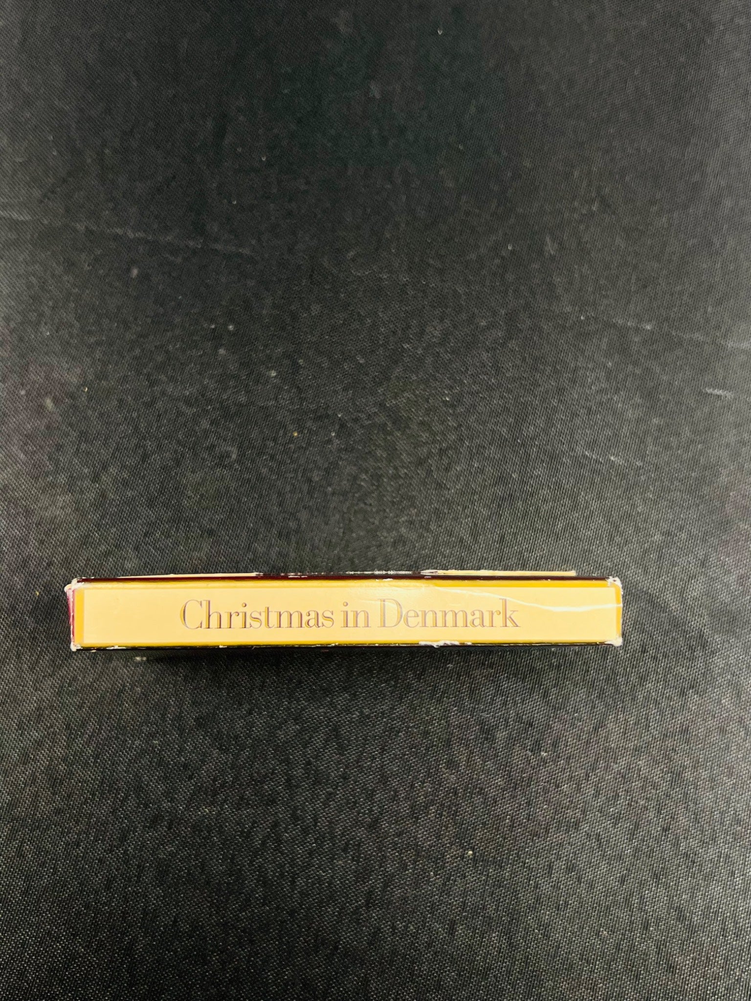 Gold book titled 'Christmas in Denmark' on a black background