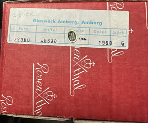 Red box with a label from Glaswerk Amberg, Amberg on a red background