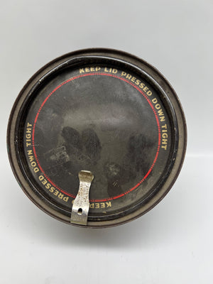 Vintage metal can lid with text on a white background