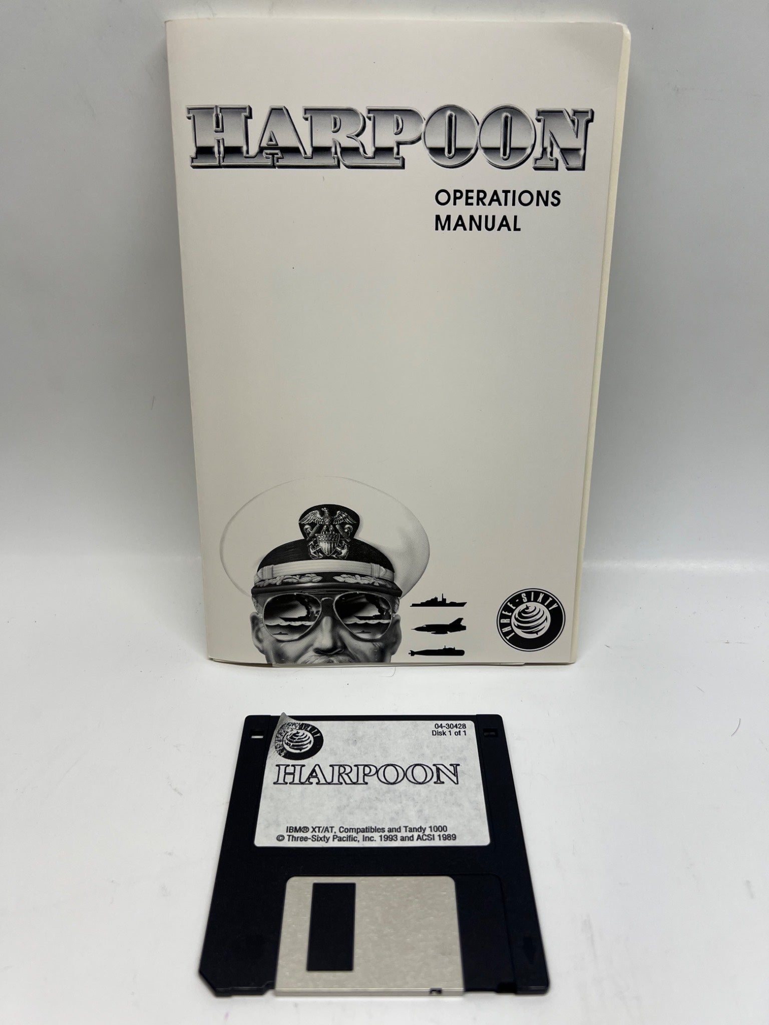 Harpoon operations manual with floppy disk on a white background