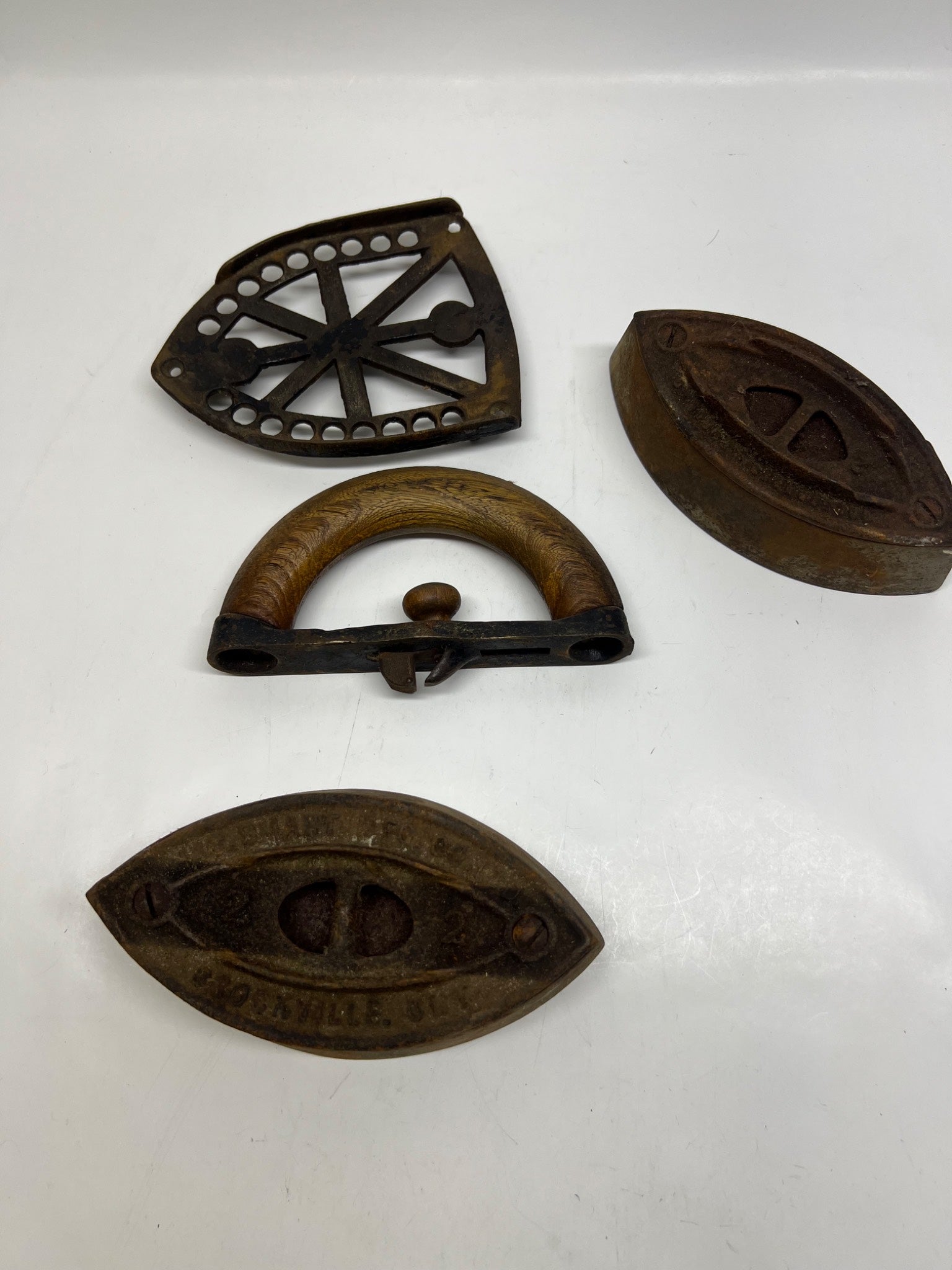 Set of four vintage metal objects on a white background