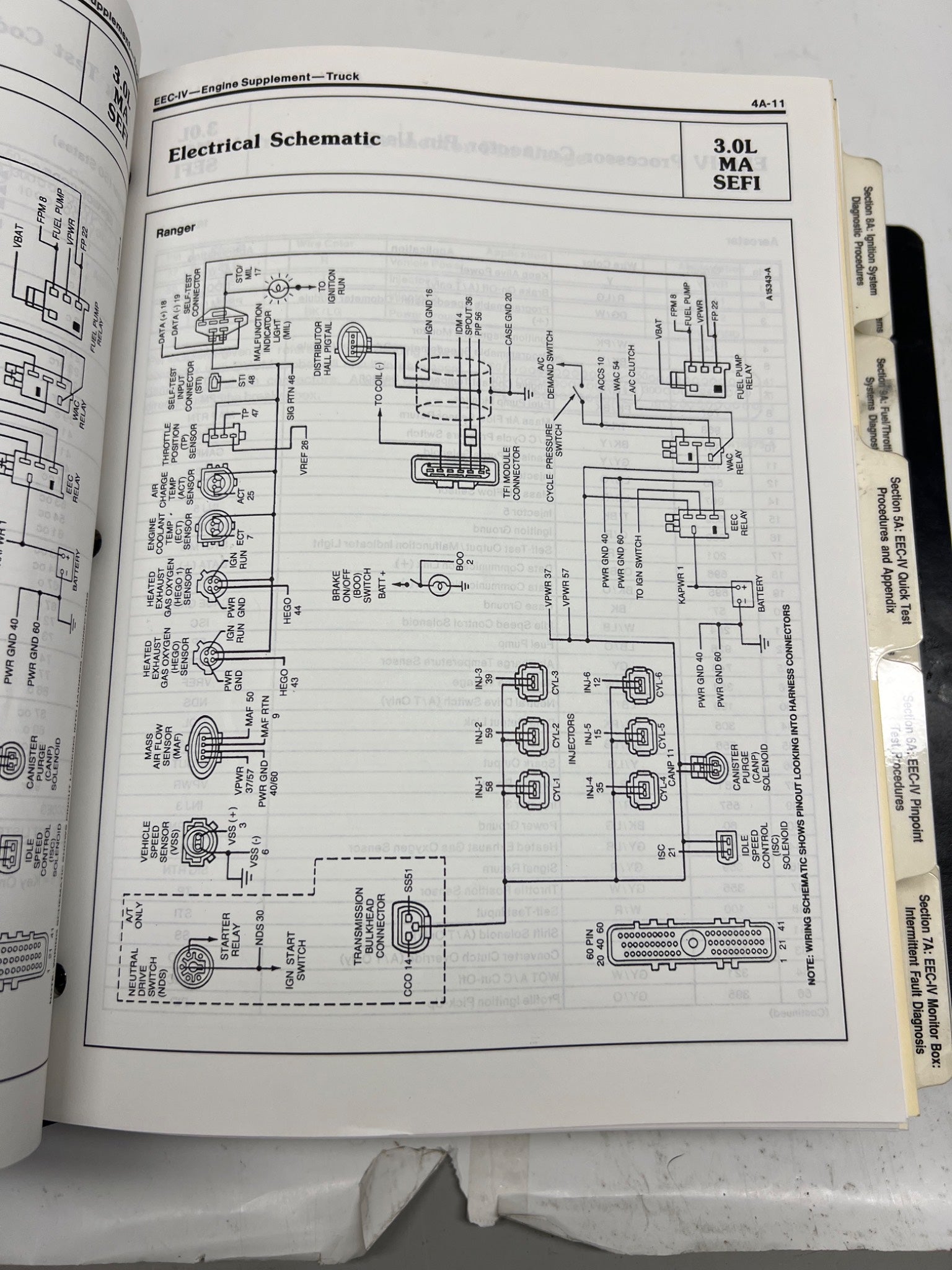 Open book showing an electrical schematic diagram on a white background